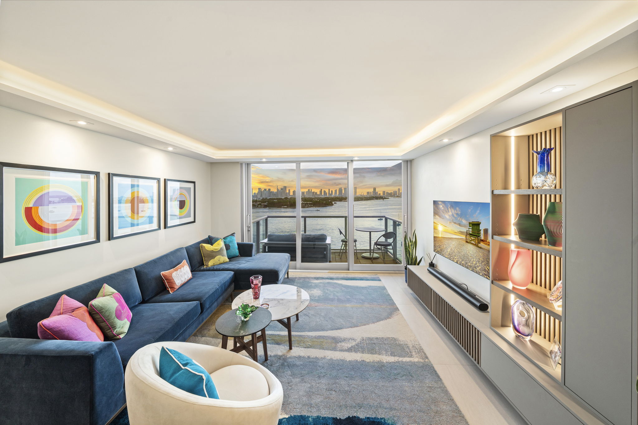 Living room with Miami skyline sunset view and custom slatted media wall